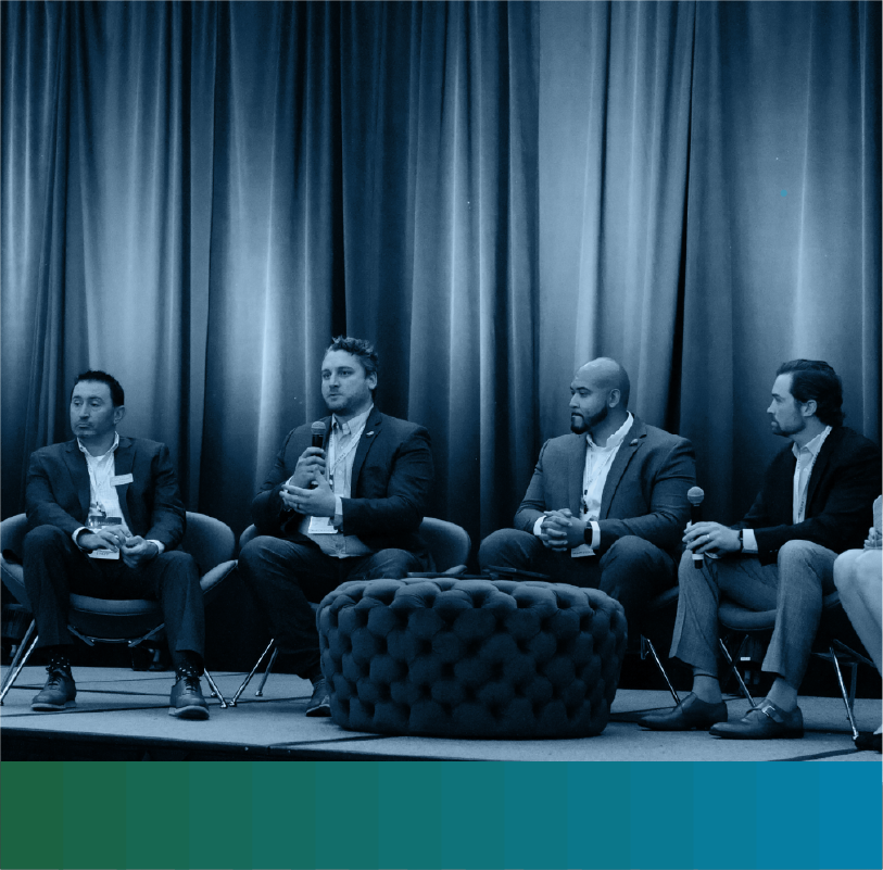 Panel of speakers on stage at TrustWeek event with green to blue gradient at the bottom