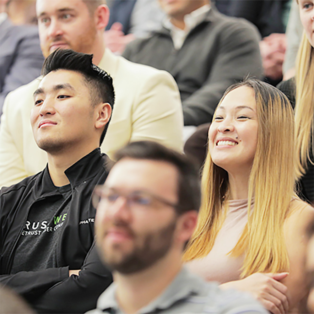 Asian team members listen to a presentation